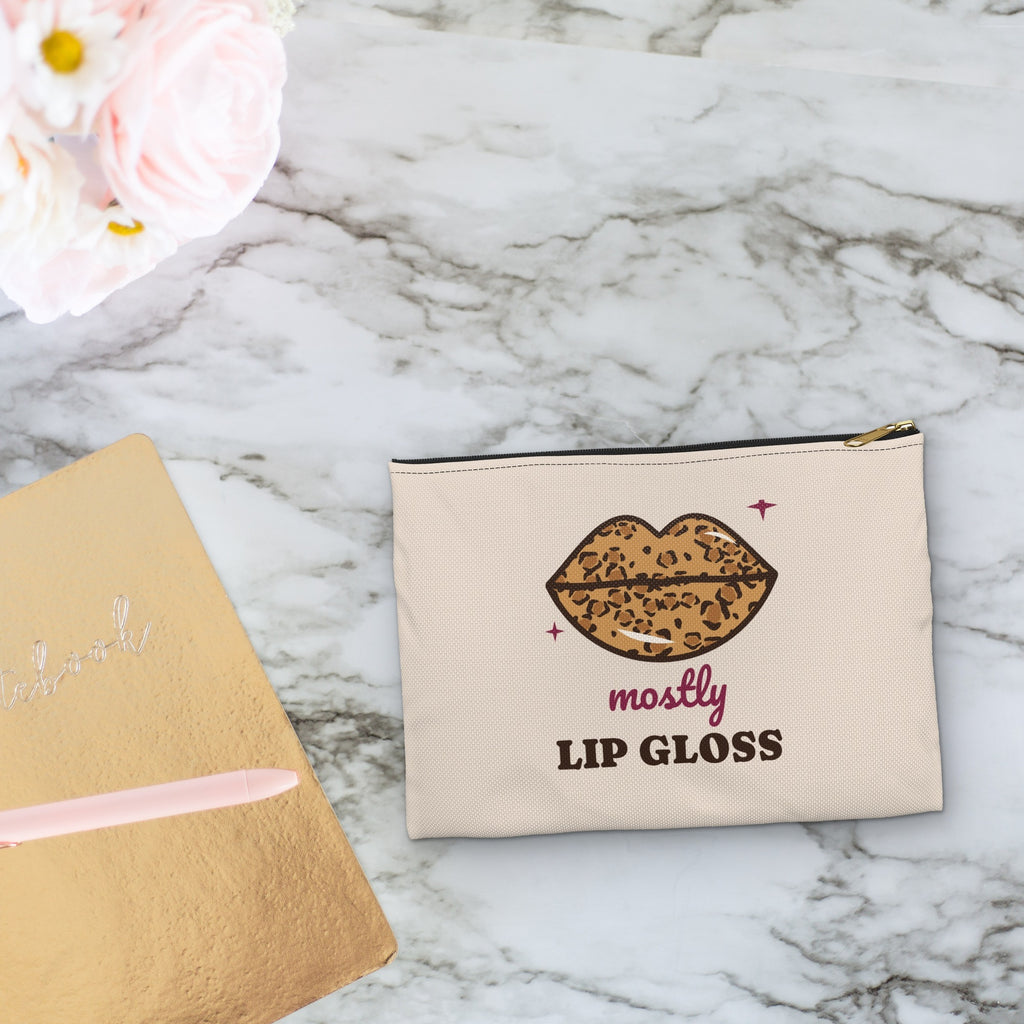 Mostly Lip Gloss makeup bag styled on a marble vanity