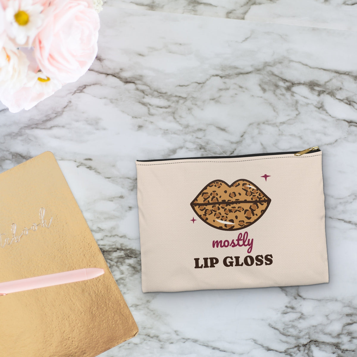 Mostly Lip Gloss makeup bag styled on a marble vanity