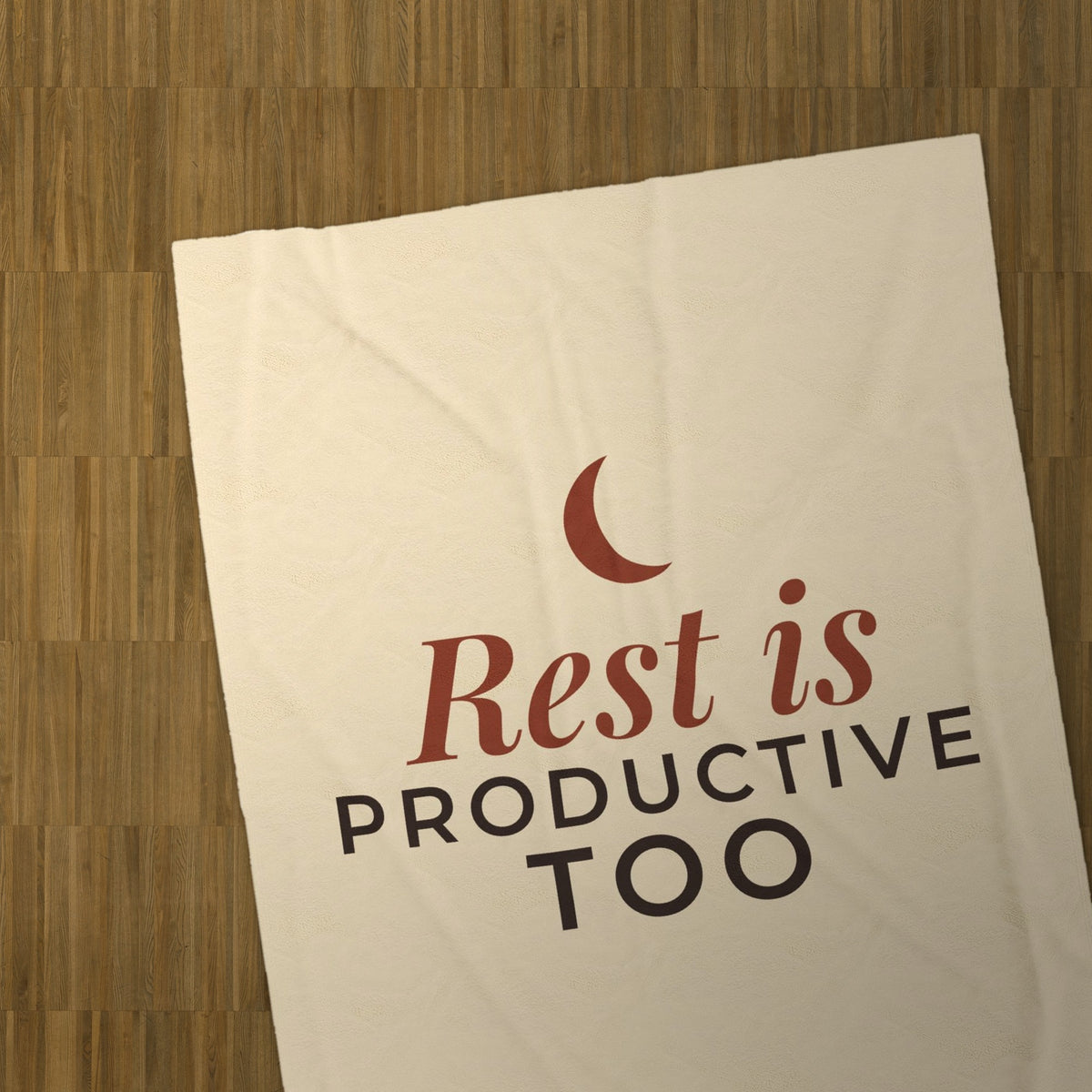 Rest Is Productive Too blanket on a parquet floor