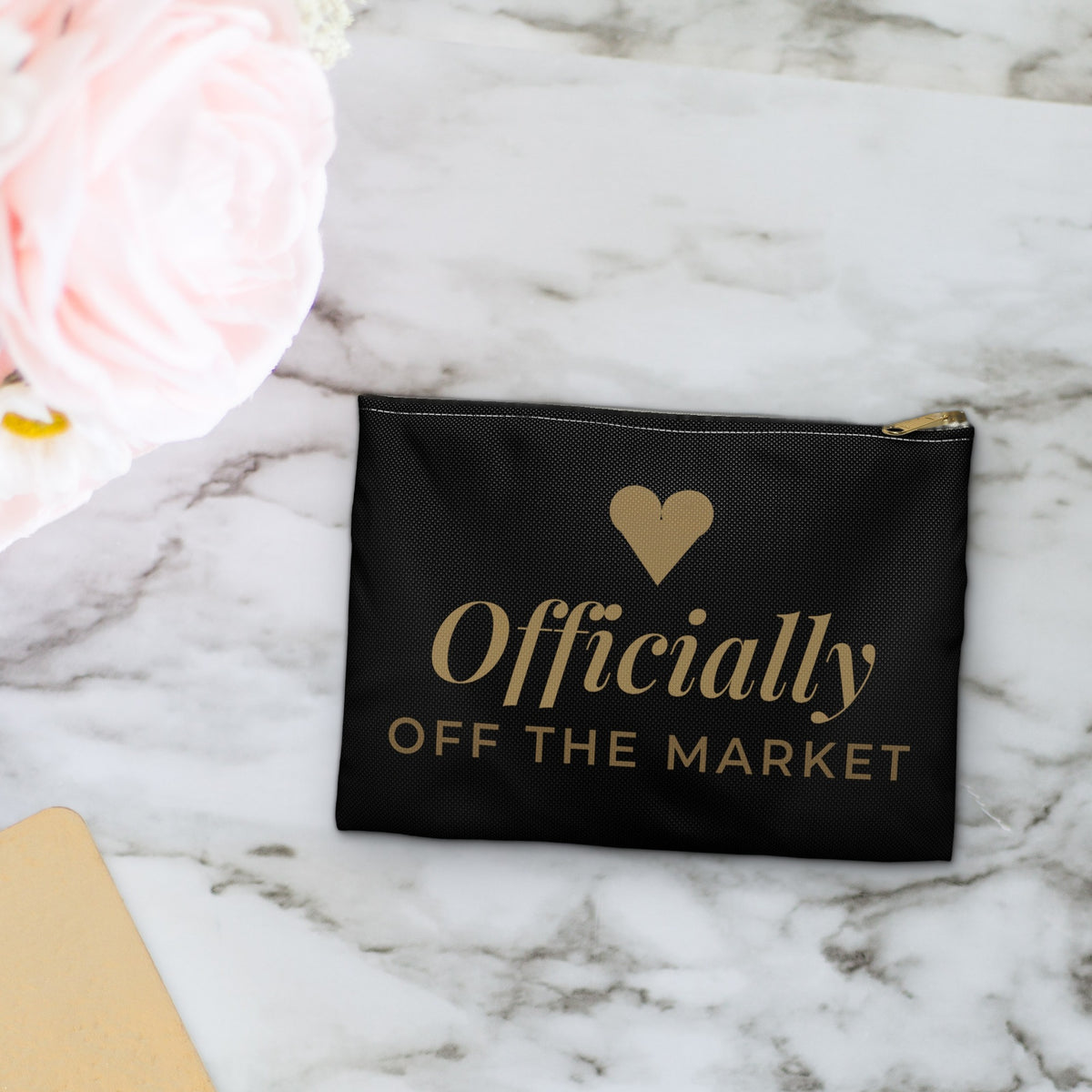 Officially Off the Market black makeup bag on marble with pink flowers