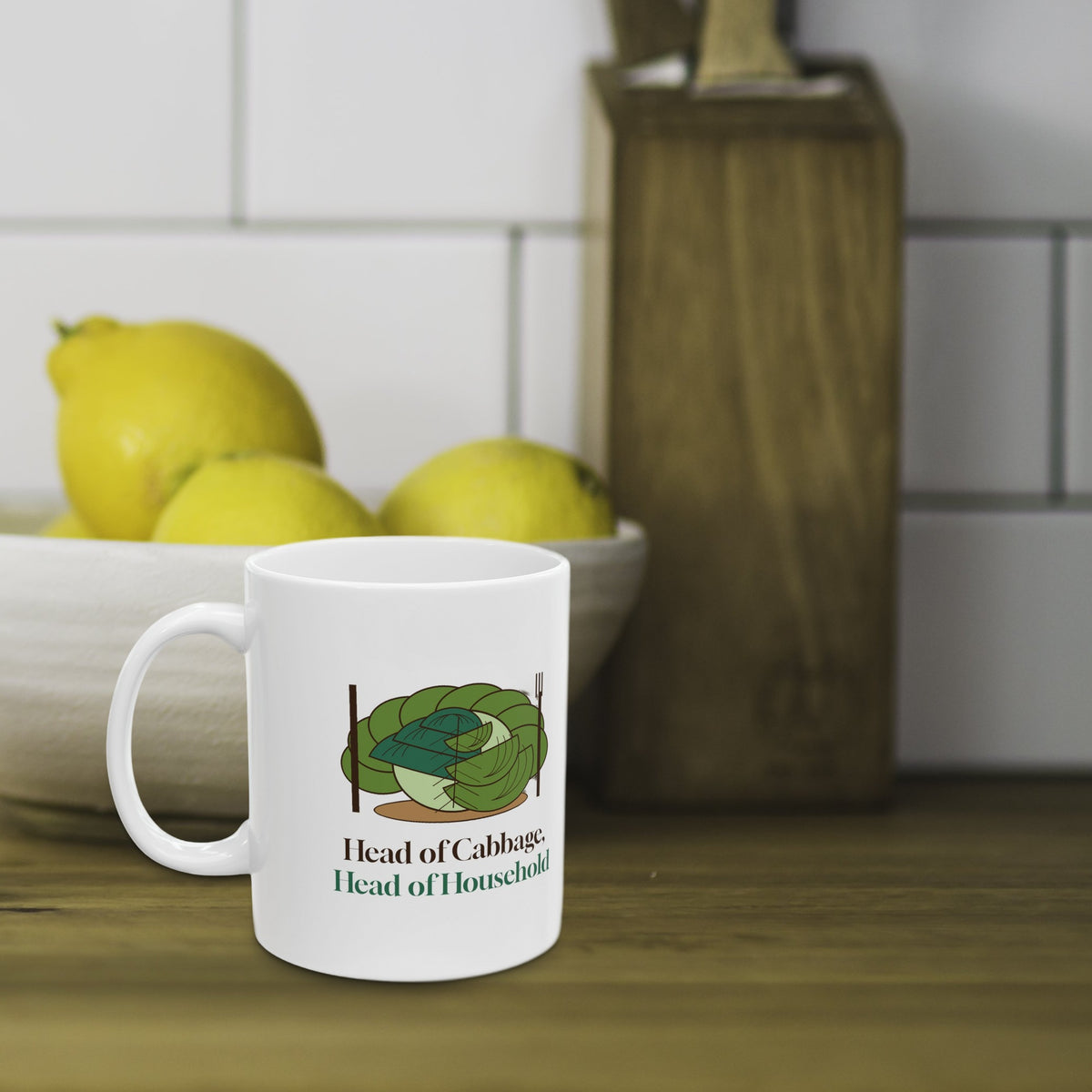 Head of Cabbage mug on a wooden kitchen counter with a bowl of lemons