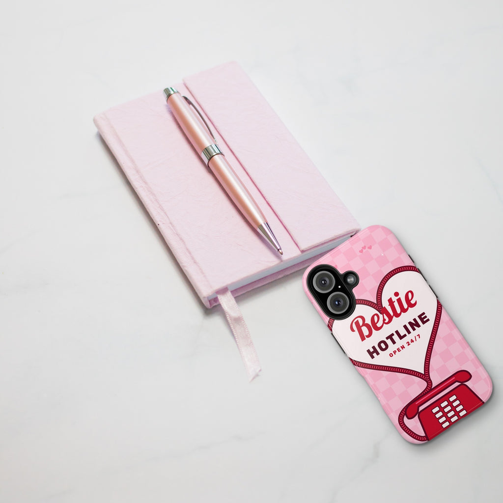 Bestie Hotline phone case styled on marble with pink journal