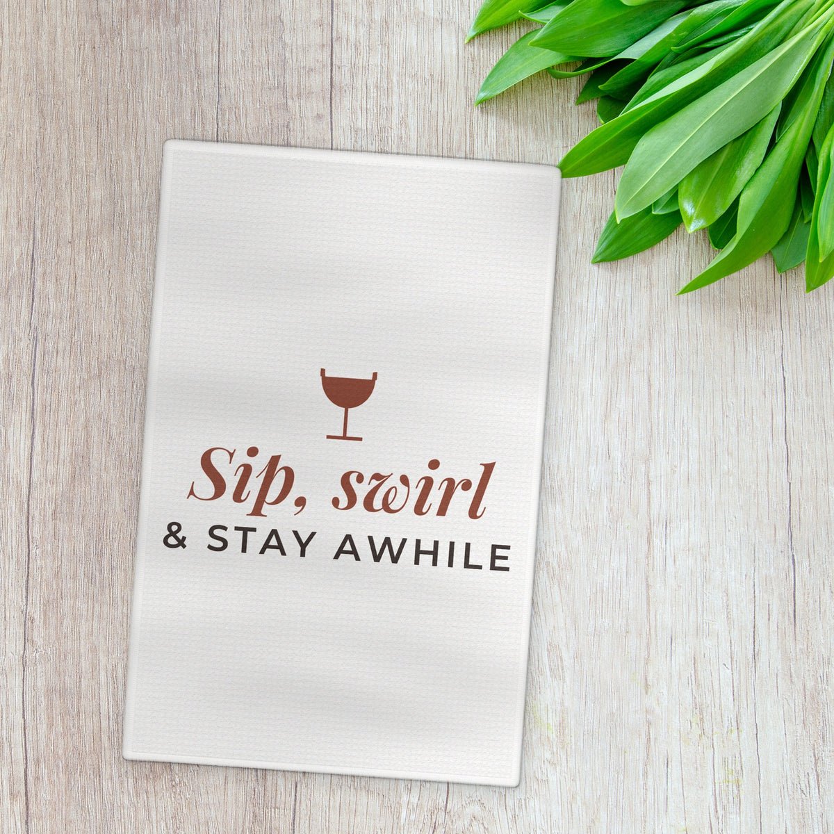 Sip Swirl and Stay Awhile tea towel styled flat lay